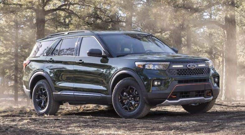 A green 2021 Ford Explorer Timberline is shown from the front at an angle.