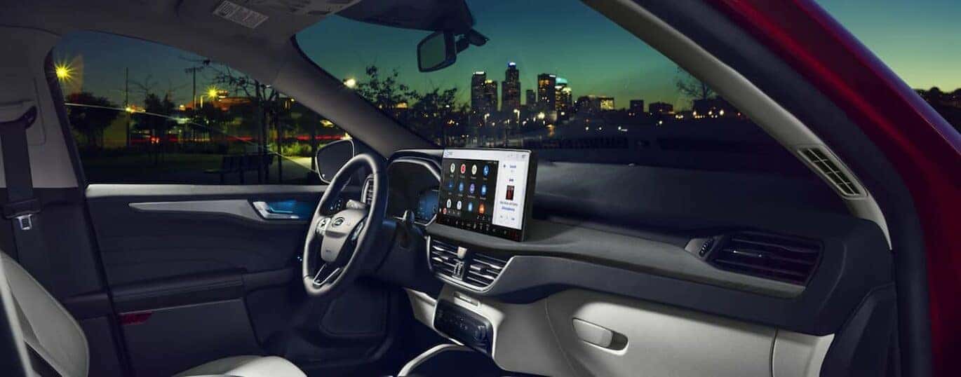 The interior of a 2023 Ford Escape shows the steering wheel and dashboard.