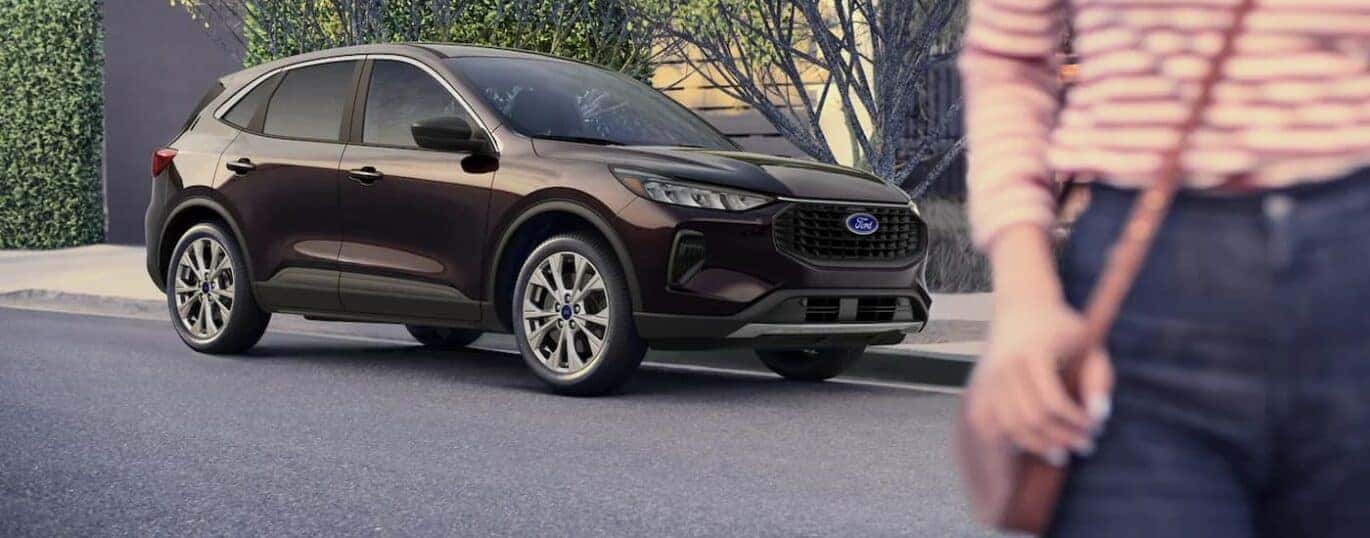 A purple 2023 Ford Escape is shown parked on the side of a city street.