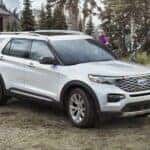 A white 2023 Ford Explorer is shown from the side.
