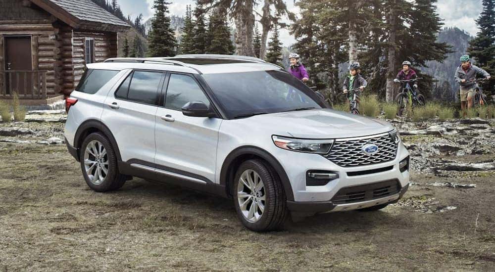 A white 2023 Ford Explorer is shown from the side.