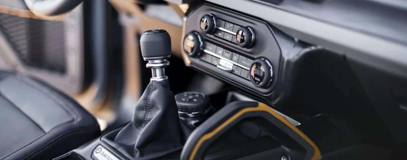 The grey interior of a 2023 Ford Bronco shows the shifter.
