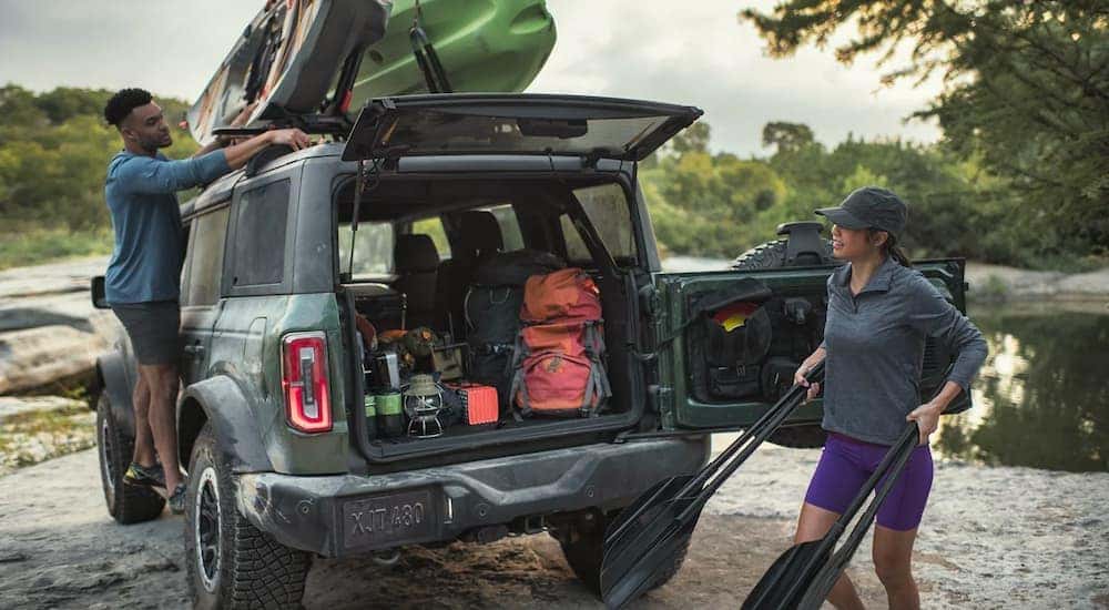 Gear is shown being unloaded from a green 2023 Ford Bronco.