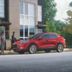 A red 2022 Ford Escape is shown from the side on a city street after leaving ond of the Ford dealerships near Troy.