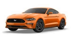 An orange 2023 Ford Mustang GT Premium is angled left.