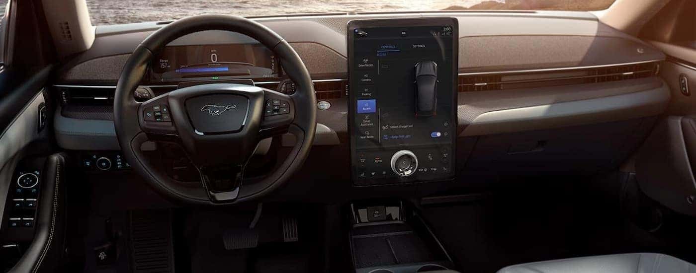 The interior of a 2021 Ford Mustang Mach-E shows the steering wheel and center console.