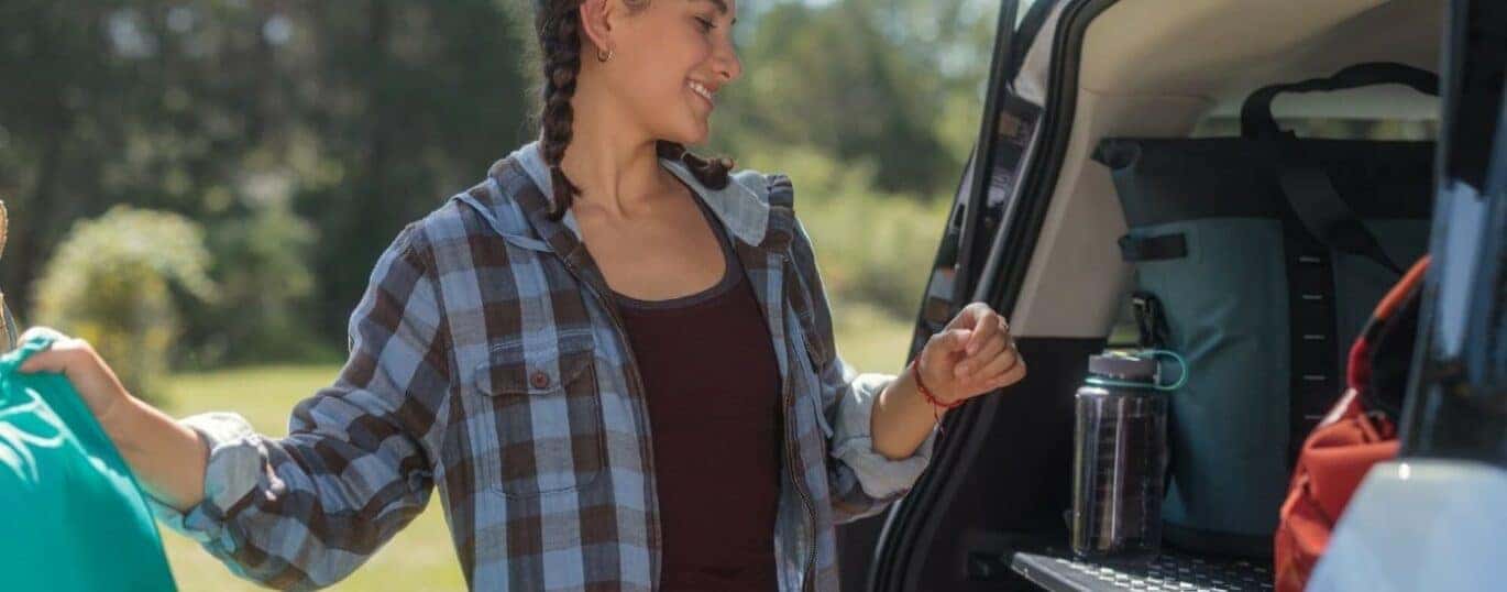 A person is shown loading gear into a 2023 Ford Bronco Sport Badlands.