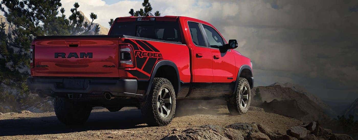 A red 2020 Ram 1500 Rebel is shown from a rear angle after viewing Saratoga, NY used truck sales.