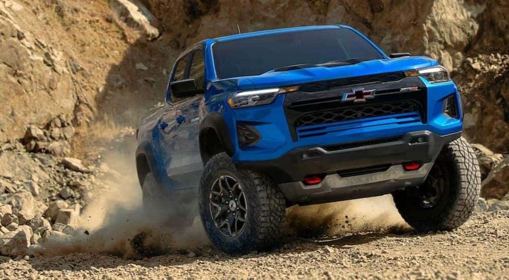 A blue 2023 Chevy Colorado ZR2 is shown off-roading after visiting Saratoga, NY used truck sales.