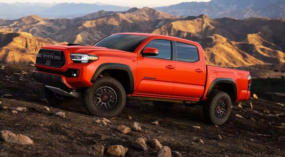 A red 2021 Toyota Tacoma TRD Pro is shown off-roading.