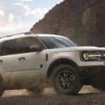 A white 2022 Ford Bronco Sport is shown from the side after leaving a used Ford SUV dealer near Amsterdam.