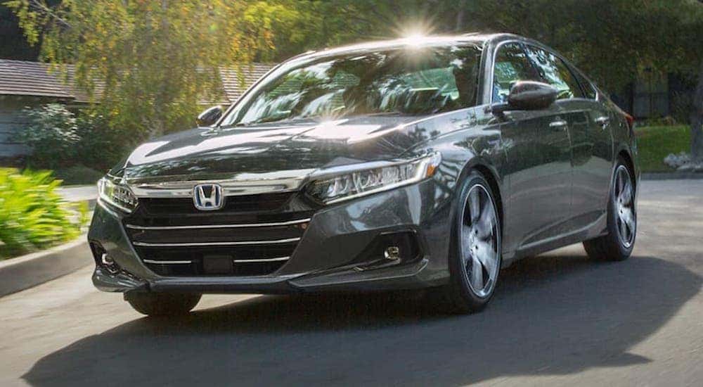 A grey 2021 Honda Accord Hybrid is shown from the front at an angle.