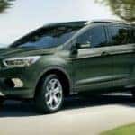 A green 2019 Ford Escape is shown from the side after leaving a used car dealer near Schenectady.
