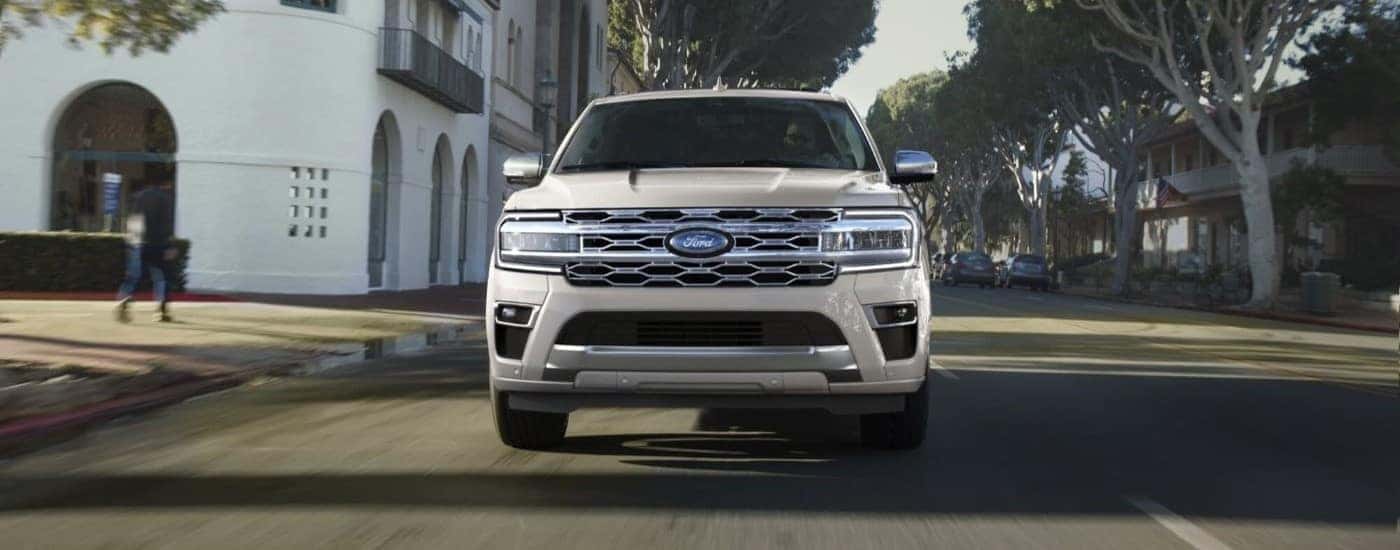 White 2023 Ford Expedition driving through a city 