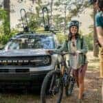 A silver 2023 Ford Bronco Sport Outer Banks is shown near bikers after visiting a Saratoga Springs Ford dealership.