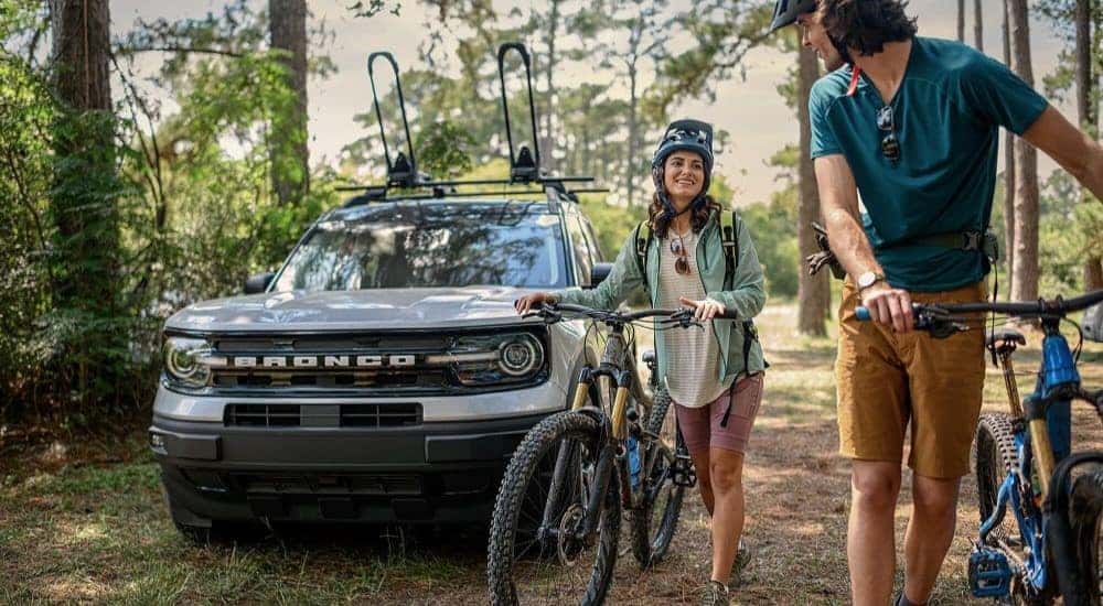 A silver 2023 Ford Bronco Sport Outer Banks is shown near bikers after visiting a Saratoga Springs Ford dealership.