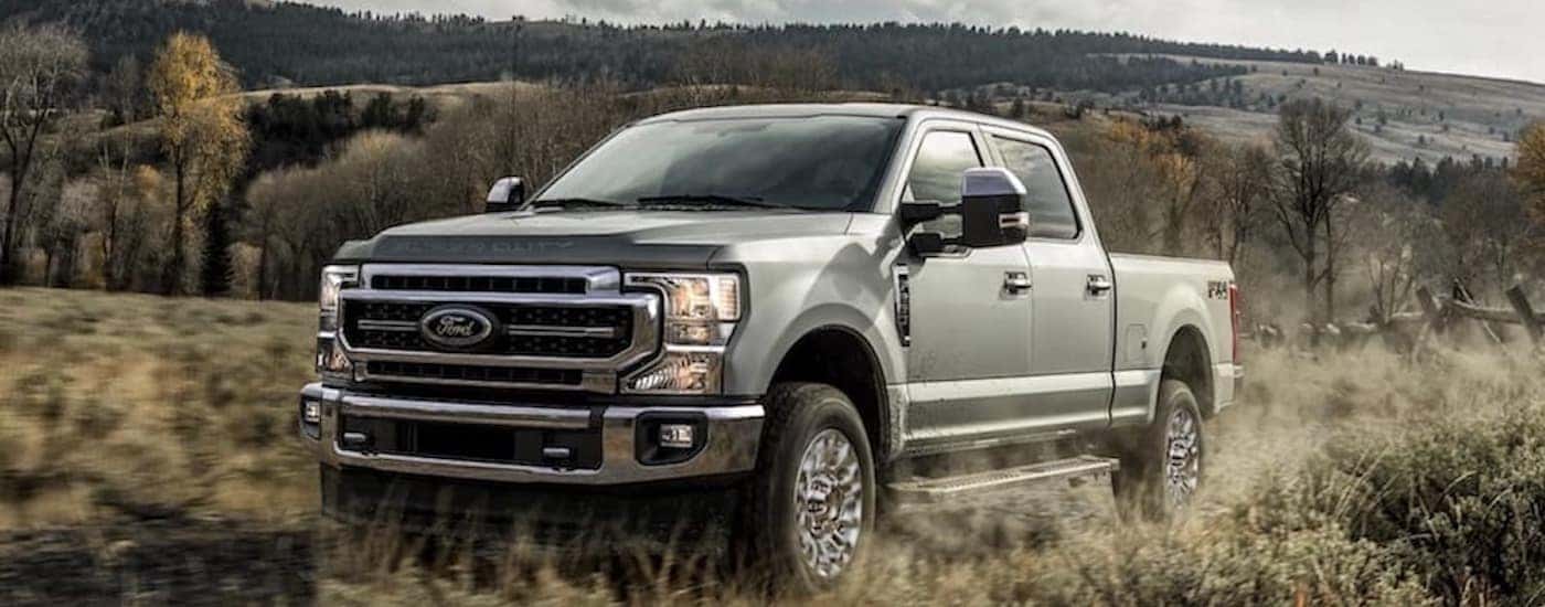 A green 2020 Ford F-250 Lariat is shown from the front at an angle.