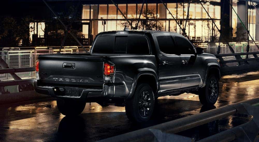 A black 2021 Toyota Tacoma Nightshade is shown parked on a bridge.