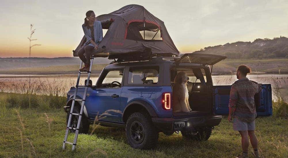 A family is shown setting up camp around a blue 2024 Ford Bronco Sport.