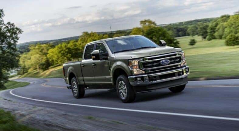 A green 2020 Ford F-250 is shown from the front at an angle after leaving a dealer that has used trucks for sale near Colonie.