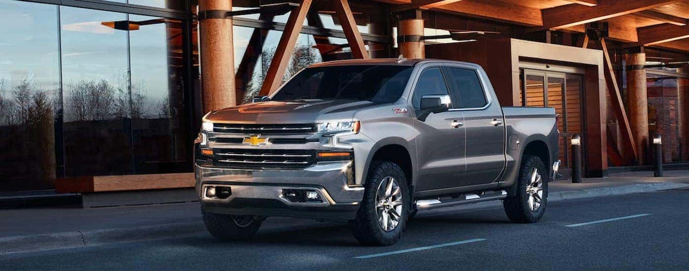 A silver 2021 Chevy Silverado 1500 is shown from the front at an angle.