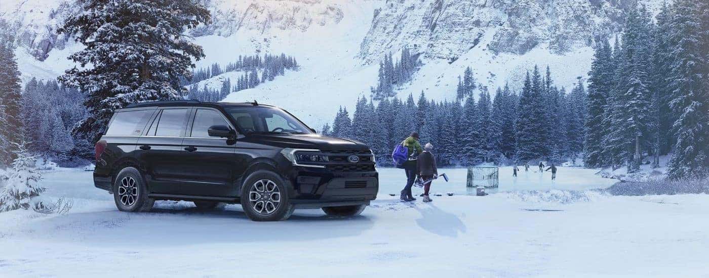 A black 2023 Ford Expedition XL STX is shown parked in a snowy forest.