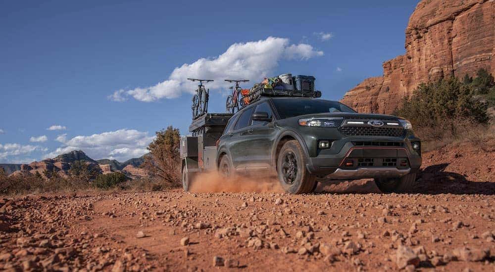 A green 2021 Ford Explorer Timberline is shown from the front at an angle.