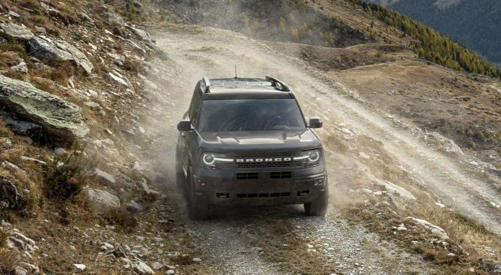A blue 2023 Ford Bronco Sport Badlands Edition is shown driving off-road.