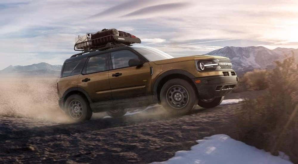 A brown 2022 Ford Bronco Sport Badlands is shown driving off-road.