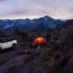 A white 2024 Ford Bronco Sport is shown parked at a campsite after a 2024 Ford Bronco Sport vs 2024 Dodge Hornet comparison.