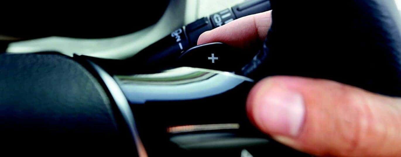 A close up shows a finger pressing the paddle shifter in a 2024 Ford Explorer.