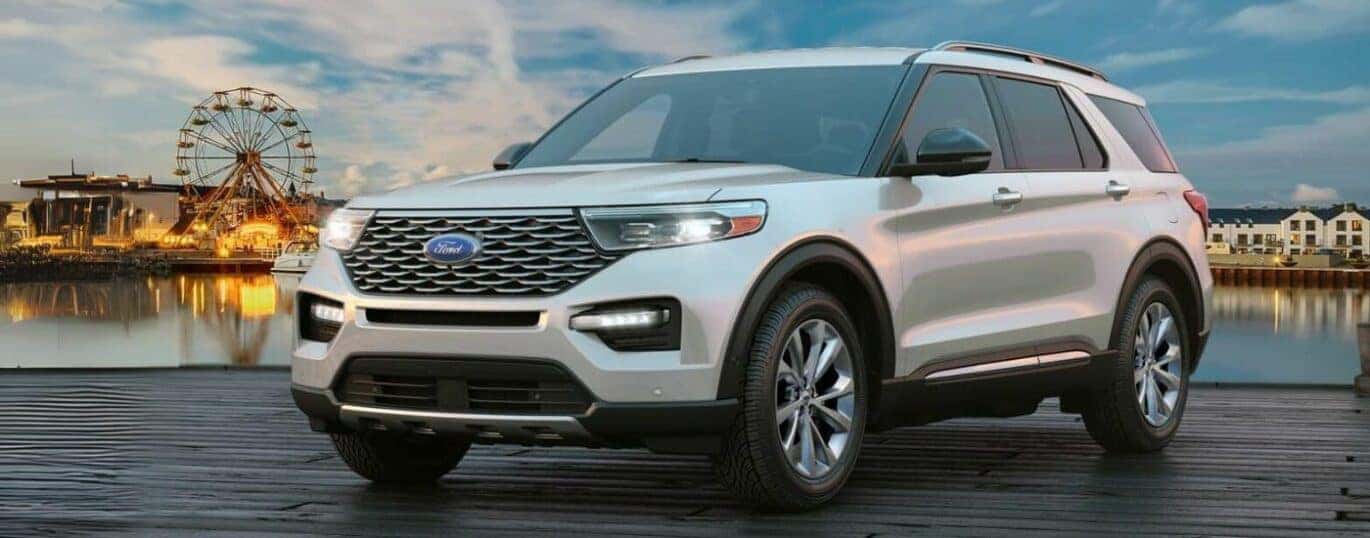 A white 2024 Ford Explorer is shown parked on a dock.