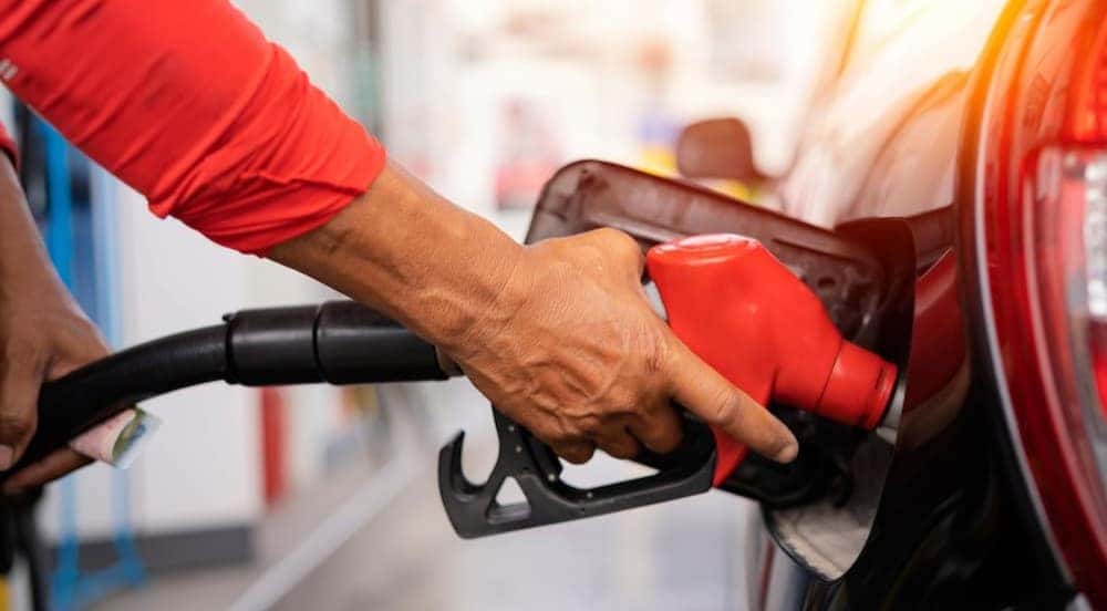 A person is shown pumping gas.