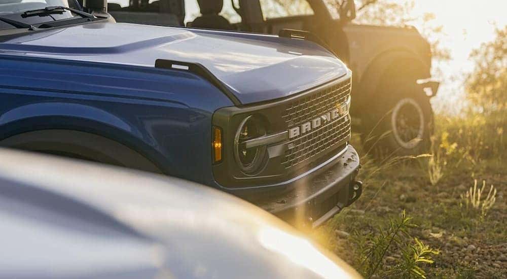 A close up of the front of a blue 2024 Ford Bronco.
