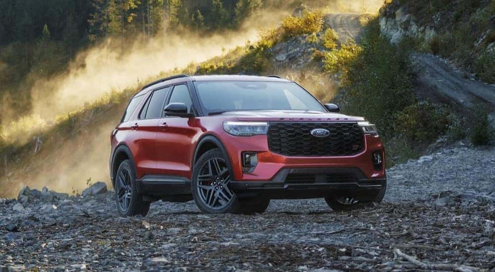 A red 2025 Ford Explorer is shown parked off-road.