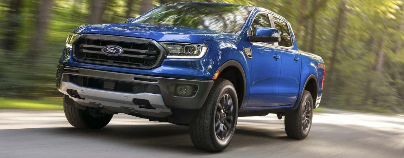 A blue 2021 Ford Ranger FX4 driving.