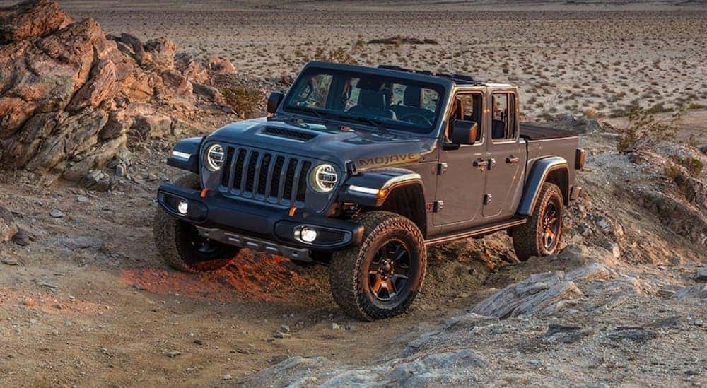 A black 2021 Jeep Gladiator driving off-road.