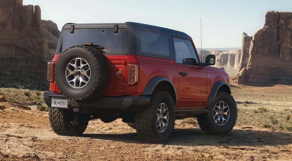 A rear view of a red 2021 Ford Bronco parked off-road.