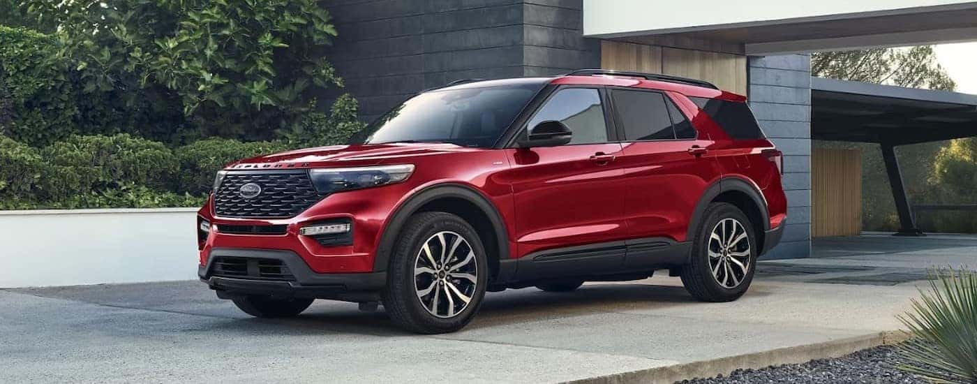A red 2024 Ford Explorer for sale is shown parked on a driveway.