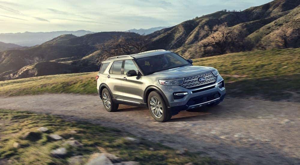 A silver 2020 Ford Explorer driving along a mountain road.