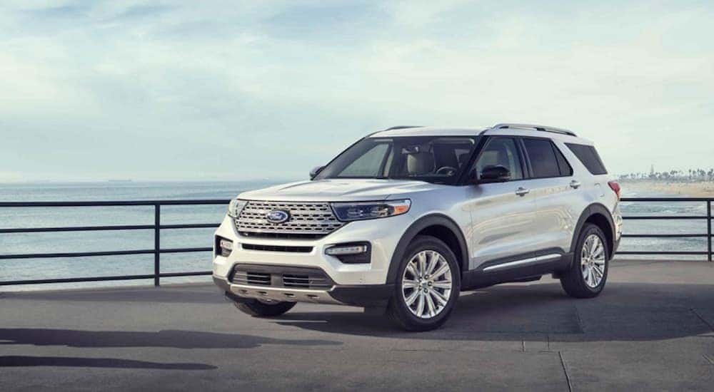 A white 2020 Ford Explorer parked by a railing.