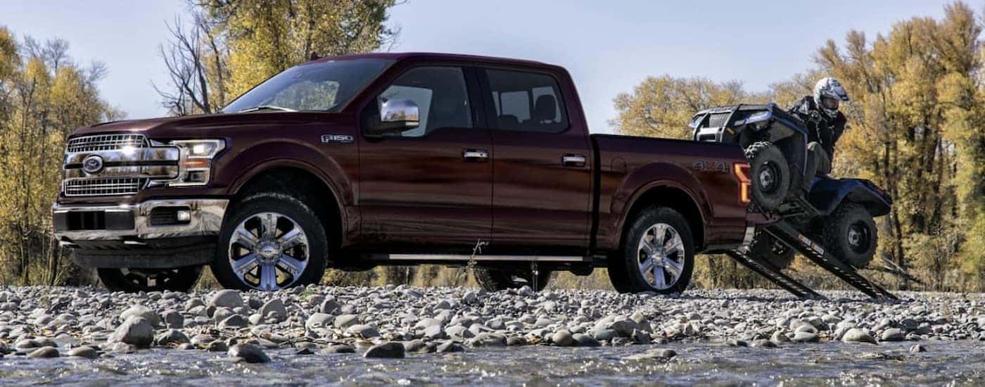 A burgundy 2020 Ford F-150 is shown parked off-road.
