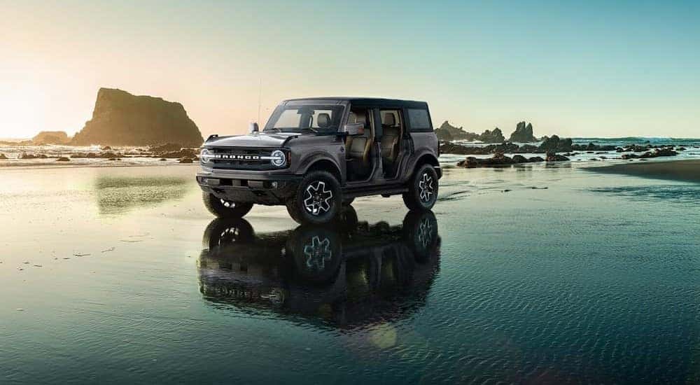A gray 2024 Bronco Outer Banks is shown parked on water.