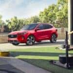 A red 2024 Ford Escape ST-Line parked outside a gym.