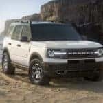 A white 2024 Ford Bronco Sport Badlands parked on the beach.