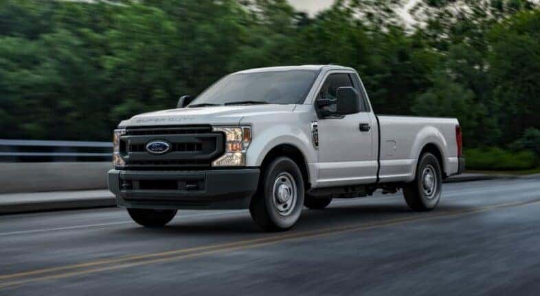 A white 2020 Ford F-250 angled left and driving.