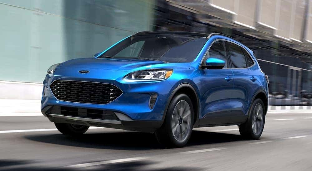 A blue 2020 Ford Escape Hybrid is shown driving after viewing a used Ford for sale in Albany.