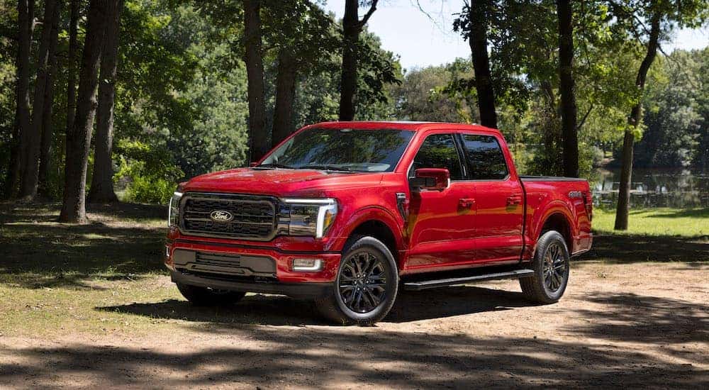 A red 2024 Ford F-150 Lariat for sale is shown from the front at an angle.