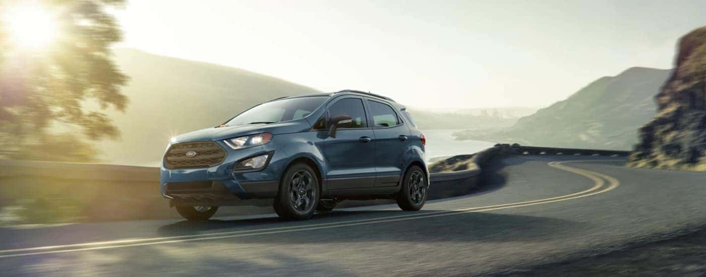 A blue 2021 Ford EcoSport is shown driving on a highway.