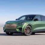 A green 2024 Ford Mustang Mach-E Gt is shown from the side during a 2024 Ford Mustang Mach-E vs 2024 Cadillac OPTIQ comparison.